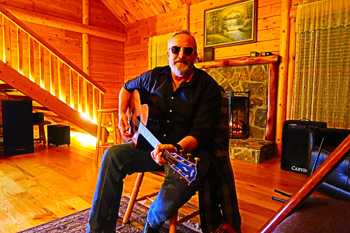 Jim Sokol playing acoustic guitar